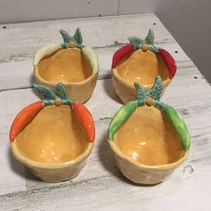 Set of four mustard yellow handcrafted signed pottery bowls w/vegetables on top